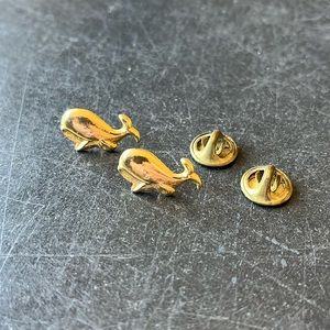 Pair of vintage whale lapel pins.
